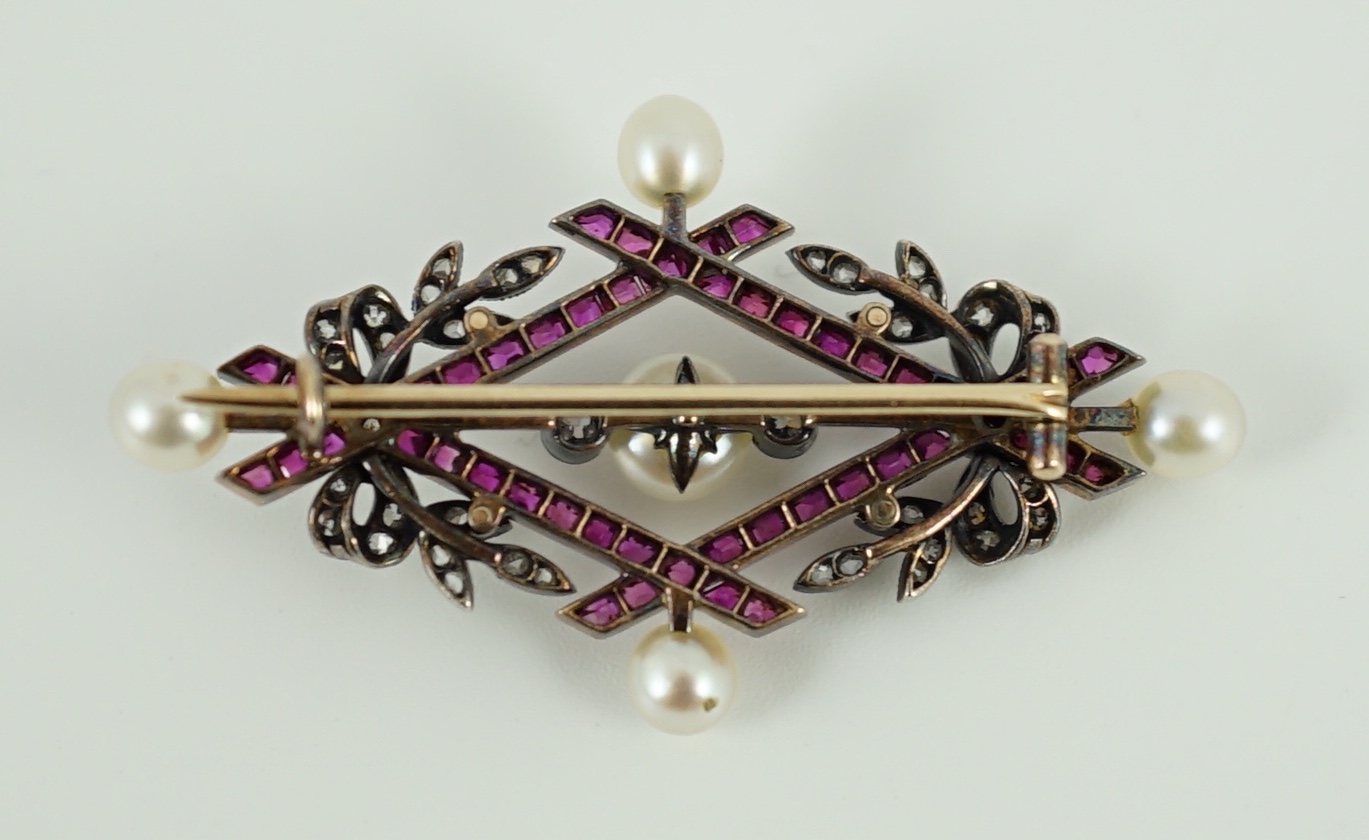 An early 20th century gold and silver, cultured pearl, ruby and diamond cluster set diamond shaped brooch